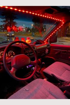 the interior of a car with red lights