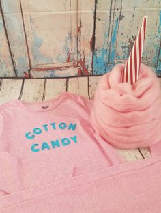 a pink shirt with the words cotton candy on it and a striped straw sticking out of it