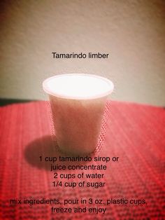 a red table topped with a cup filled with liquid