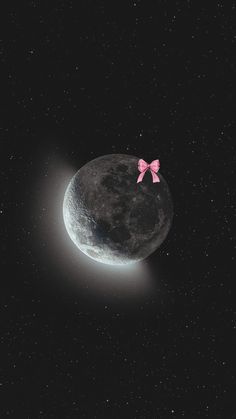 a pink bow sitting on top of the moon