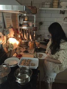 a woman is preparing food in the kitchen