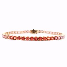 Elevate your style with our exquisite 9.37 Cts. Pink to Red Sapphire & Ruby Tennis Bracelet. Crafted with precision, this bracelet features stunning gemstones that range from vibrant pink to deep red, offering a unique and luxurious touch to any outfit. Make a statement and indulge in luxury with this exclusive piece. GEMS 9.37 RD TCW 48 PCS. RED TO PINK18K YG 10.34 GRAMS SIZE 7" MD-122