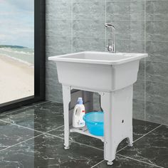 a white sink sitting on top of a tiled floor