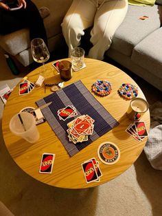 a wooden table topped with lots of stickers and cards on top of a couch