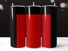 three red and black candles are on the table