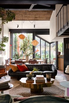 a living room filled with furniture and lots of windows