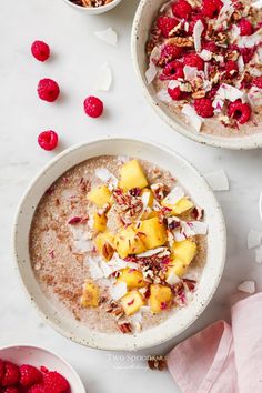 two bowls of oatmeal with raspberries and coconut on the side