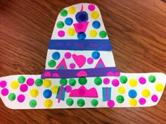 a craft made out of paper with polka dots and a hat on top of it