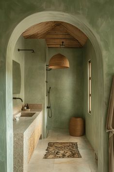 an archway leading to a bathroom with a rug on the floor and a sink under it