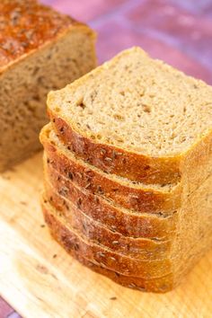 sliced bread sitting on top of a wooden cutting board