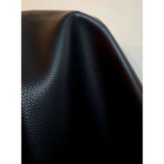 black leather textured up close with white background