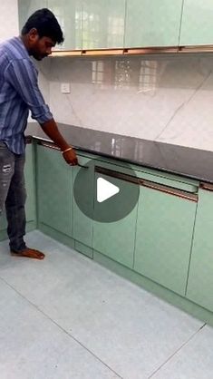 a man standing in front of a kitchen counter