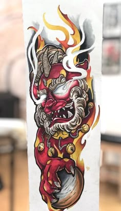 a piece of paper with a drawing of a demon on it's face and flames coming out of its mouth