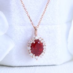 This timelessly elegant oval ruby necklace is set in the lustrous 14k gold tiara halo diamond drop pendant featuring an oval-shaped vivid red ruby surrounded by brilliant white diamonds that dangle beautifully from a solid gold cable chain. The length of the gold chain can be adjusted to either 16" or 18" long to suit your style! This ruby and diamond necklace can be crafted in your choice of white, rose, or yellow gold. ** The listing price is for one necklace only Availability: Ready to Ship: