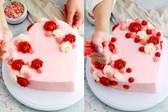 two people are decorating a heart shaped cake with red and white flowers on it