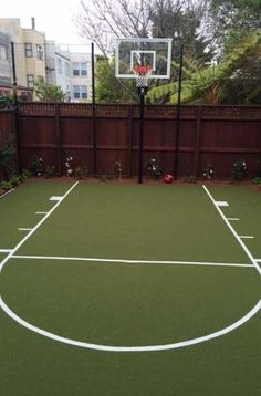 an outdoor basketball court in the backyard