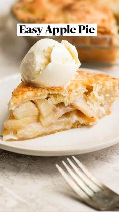 a piece of pie with ice cream on top sits on a plate next to a fork