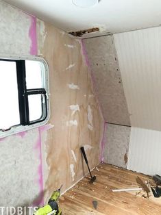 a room that is being remodeled with wood flooring and walls torn off from the wall