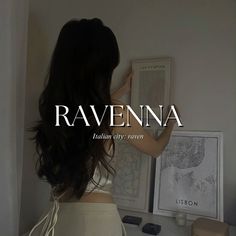 the back of a woman's head in front of a white wall with ravenna on it