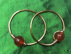 Replica of beautiful temple rings. Original was made of gold my repeated in copper with a carnelian beads. Those temple rings will be perfect addition to your Slavic costume. They will work for SCA, Adrian empire, and Living history events. If you would like to have similar temple rings made of different material: brass or silver, or with a different beads (gemstone or glass) just message me. I will be happy to make custom pair. Temple Rings Slavic, Temple Rings, Medieval Reenactment, Kievan Rus, The Reckoning, Copper Mountain, Woven Headband, Weaving Tools, History Events