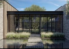 an artistic rendering of a glass house with water in the foreground and stone walkway leading up to it