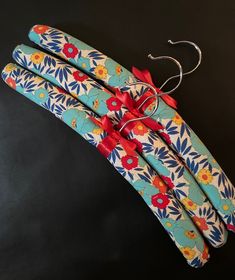 three blue and red flowered sticks tied to each other on a black table top