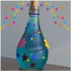 a bottle with stars painted on it and the words live's dream written inside