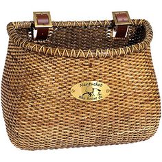 a brown wicker basket with two handles on the front and one handle at the bottom