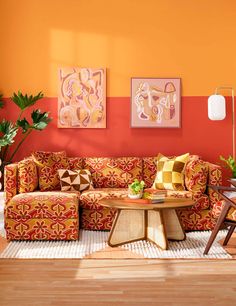 a woman sitting on top of a couch in a living room