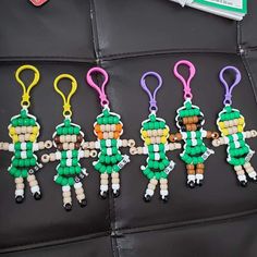 four beaded keychains with different colors and designs on them, each featuring a soldier