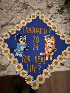 a blue graduation cap with two cartoon characters on it that says, i graduated 20 for real life?