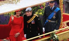 the royal couple are posing for pictures on their red carpeted carriage as they stand next to each other