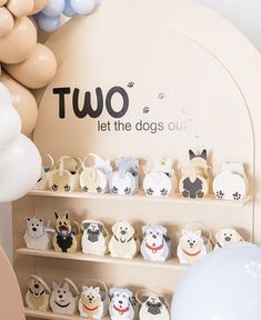 there is a display case with dogs on it and balloons in the air behind it