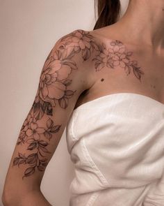 a woman with a flower tattoo on her arm