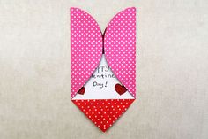 an origami valentine's day bow with polka dots