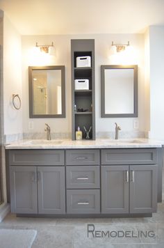 a bathroom with double sinks and two mirrors