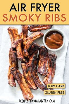 air fryer smoky ribs on parchment paper with dipping sauce in the middle and text overlay