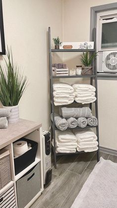 the bathroom is clean and ready to be used as a storage area for folded towels