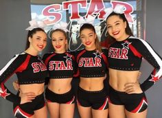 the cheerleaders are posing for a photo in front of a star sign with their pom - poms