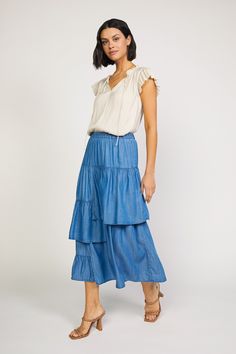 This chambray asymmetrical tiered midi skirt features an elastic waistband for a comfortable and adjustable fit. Its quality construction and fabric provides maximum durability, perfect for everyday wear. The varied length tiers create a flattering silhouette for any body shape. •Relaxed fit •A Line Cut •Tiered Detail •Elastic Waist DIMENSIONS •Standard: 31.25" Length Item number 2250051 100% Lyocell ♦ Lyocell is an eco-friendly fabric that reduces water usage while utilizing regenerated natural Nashville Outfits Summer, Tiered Midi Skirt, A Line Cut, Nashville Outfits, Water Usage, Print Trends, Tiered Skirt, Trending Dresses, Body Shape