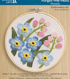 an embroidery kit with blue and pink flowers