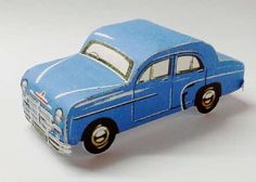 a blue toy car sitting on top of a white table