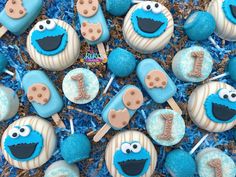 blue and white cake pops decorated like sesame street characters with the number one on them