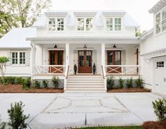 a white house with lots of windows and doors