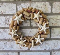 a wreath made out of wine corks with white starfish on the front and back