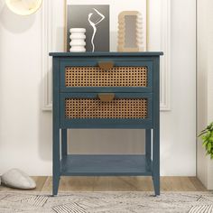 a blue nightstand with wicker baskets on top and a white wall in the background