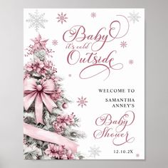 a baby shower sign with pink bows and snowflakes