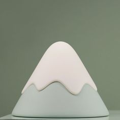 a white lamp sitting on top of a table