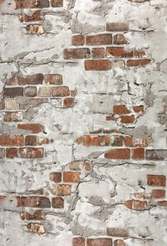 an old brick wall that has been painted white and red with some rust on it