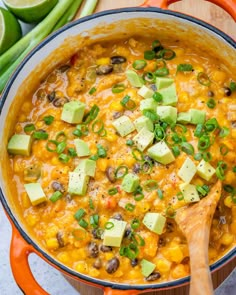 a white bowl filled with mexican soup and topped with avocado